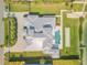 Aerial view of the home showcasing the roof, pool, bocce ball court, and dock at 472 Desoto Dr, New Smyrna Beach, FL 32169