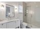 Bright bathroom featuring modern fixtures, a glass-enclosed shower, and a sleek vanity at 472 Desoto Dr, New Smyrna Beach, FL 32169