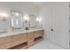 An elegant bathroom features a double sink vanity with marble counters and mosaic tile walls at 472 Desoto Dr, New Smyrna Beach, FL 32169