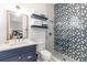 Bathroom featuring a shower and a blue and white tiled wall at 472 Desoto Dr, New Smyrna Beach, FL 32169