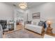 Sunlit bedroom with daybed, stylish decor, and a glimpse into the inviting living space at 472 Desoto Dr, New Smyrna Beach, FL 32169