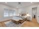 A light-filled bedroom with a ceiling fan, shuttered windows, and light-colored flooring at 472 Desoto Dr, New Smyrna Beach, FL 32169