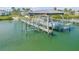 A boat lift ensures easy boat storage and maintenance, enhancing waterfront living experience at 472 Desoto Dr, New Smyrna Beach, FL 32169