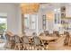 Dining area with a large table, seating for ten, and a stylish light fixture at 472 Desoto Dr, New Smyrna Beach, FL 32169
