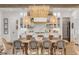 Bright dining room featuring a large wooden table, wicker chairs, and beaded chandelier, seamlessly connected to the modern kitchen at 472 Desoto Dr, New Smyrna Beach, FL 32169