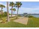 Palm-lined pathway leads to a private dock with stunning waterfront views at 472 Desoto Dr, New Smyrna Beach, FL 32169