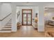 Inviting entryway featuring hardwood floors, a bench, and views of a staircase at 472 Desoto Dr, New Smyrna Beach, FL 32169