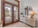 Beautiful foyer with double doors, herringbone wood floors, and stylish console table at 472 Desoto Dr, New Smyrna Beach, FL 32169