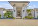 Elegant home entrance featuring a covered porch and decorative landscaping for inviting appeal at 472 Desoto Dr, New Smyrna Beach, FL 32169