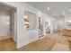 Bright hallway showcasing wood floors and an open floorplan with views into other rooms at 472 Desoto Dr, New Smyrna Beach, FL 32169