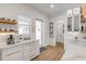 Bright and airy kitchen featuring custom cabinetry, quartz countertops, stainless steel appliances, and ample natural light at 472 Desoto Dr, New Smyrna Beach, FL 32169