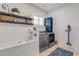 Functional laundry room with a pet washing station, modern washer and dryer, and stylish decor at 472 Desoto Dr, New Smyrna Beach, FL 32169