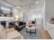 Bright living room featuring modern decor, a wet bar, and an upstairs balcony at 472 Desoto Dr, New Smyrna Beach, FL 32169