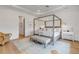 Spacious main bedroom with a four-poster bed, tasteful decor and an inviting atmosphere at 472 Desoto Dr, New Smyrna Beach, FL 32169