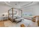 Serene bedroom with a four poster bed, water views, and ample natural light at 472 Desoto Dr, New Smyrna Beach, FL 32169