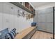 Functional mudroom features built-in storage, a bench with pillows, and stylish hooks for organization at 472 Desoto Dr, New Smyrna Beach, FL 32169