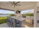 Outdoor bar area with stylish seating, built-in grill, and stunning waterfront view at 472 Desoto Dr, New Smyrna Beach, FL 32169
