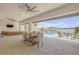 Expansive covered patio with dining area, outdoor seating, and a beautiful waterfront view at 472 Desoto Dr, New Smyrna Beach, FL 32169
