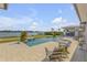 Stunning pool area with elegant lounge chairs, lush landscaping, and serene waterfront setting at 472 Desoto Dr, New Smyrna Beach, FL 32169