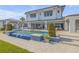 A pristine pool features vibrant blue tiling and multiple seating areas for relaxation at 472 Desoto Dr, New Smyrna Beach, FL 32169