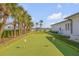 A private putting green offers a fun activity in the beautifully landscaped backyard at 472 Desoto Dr, New Smyrna Beach, FL 32169