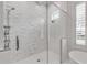 The walk-in shower features gorgeous tile, a showerhead, and glass enclosure at 472 Desoto Dr, New Smyrna Beach, FL 32169
