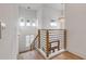 A modern staircase featuring wood steps, metal railing, and abundant natural light at 472 Desoto Dr, New Smyrna Beach, FL 32169