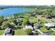 Scenic aerial view of a lakefront property surrounded by lush greenery at 917 E Valencia St, Lakeland, FL 33805