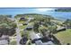 Aerial shot featuring a beautiful lake view, surrounded by trees, landscaping and neighborhood at 917 E Valencia St, Lakeland, FL 33805