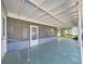 Back porch featuring screened-in section and a door leading to the backyard at 917 E Valencia St, Lakeland, FL 33805