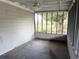 Cozy screened-in back porch with a ceiling fan and view of the landscaped backyard at 917 E Valencia St, Lakeland, FL 33805