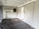 Back porch area featuring grey brick walls, a window, and an exterior door at 917 E Valencia St, Lakeland, FL 33805