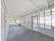Enclosed back porch with concrete flooring, ceiling fans, and views of the outdoors at 917 E Valencia St, Lakeland, FL 33805