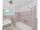 A quaint bathroom featuring a shower and tub, as well as a sink and toilet at 917 E Valencia St, Lakeland, FL 33805