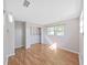 Bright bedroom features hardwood floors, a window view, closet, and modern lighting at 917 E Valencia St, Lakeland, FL 33805