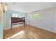 Bright bedroom with wood floors and two windows for ample natural light at 917 E Valencia St, Lakeland, FL 33805