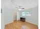 This bedroom features hardwood floors, a ceiling fan, a storage cabinet, and closet at 917 E Valencia St, Lakeland, FL 33805