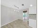 Bright dining area with modern light fixture, gray walls and light-colored wood flooring at 917 E Valencia St, Lakeland, FL 33805