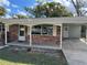 Charming brick home with a covered carport, showcasing well-maintained exteriors and a welcoming entrance at 917 E Valencia St, Lakeland, FL 33805