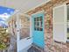 Charming brick home features a quaint porch and a bright blue front door at 917 E Valencia St, Lakeland, FL 33805