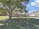 Charming brick home with a large, shady tree in the front yard at 917 E Valencia St, Lakeland, FL 33805