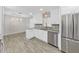 Open kitchen with stainless appliances, granite counters, and modern cabinetry at 917 E Valencia St, Lakeland, FL 33805