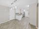 Open concept kitchen and dining room featuring modern light fixtures and stainless steel appliances at 917 E Valencia St, Lakeland, FL 33805