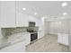 Well-lit kitchen with stainless steel appliances and modern white cabinetry at 917 E Valencia St, Lakeland, FL 33805