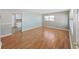 Sun-filled Living Room features hardwood floors, neutral paint and light-filled window at 917 E Valencia St, Lakeland, FL 33805