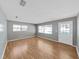 Inviting living room with light gray walls, hardwood floors and natural light from multiple windows at 917 E Valencia St, Lakeland, FL 33805