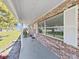 Charming brick home with a quaint porch and white shutters and trim at 917 E Valencia St, Lakeland, FL 33805