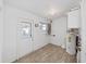 The utilitarian room features a modern water heater, window, and door for ease of access at 917 E Valencia St, Lakeland, FL 33805