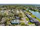 Aerial view of a charming neighborhood featuring tree-lined streets and waterfront views on a sunny day at 1730 John Arthur Way, Lakeland, FL 33803