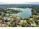 Wide aerial shot of the home showing nearby lake, landscaping, and surrounding neighborhood at 1730 John Arthur Way, Lakeland, FL 33803